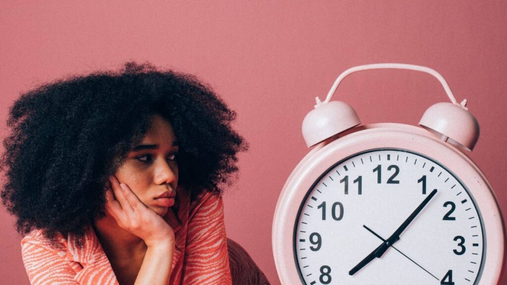 Person with clock on pink background - referral marketing stops working